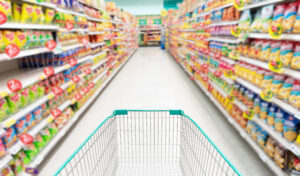 Shopping cart with Abstract supermarket grocery store refrigerator blurred defocused background
